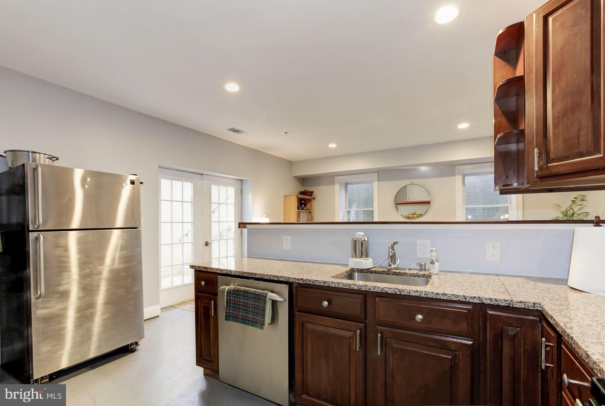 3406 Glorus Place Silver Spring, MD 20902 - Photo 44 of 53 a kitchen with granite countertop a refrigerator and a sink