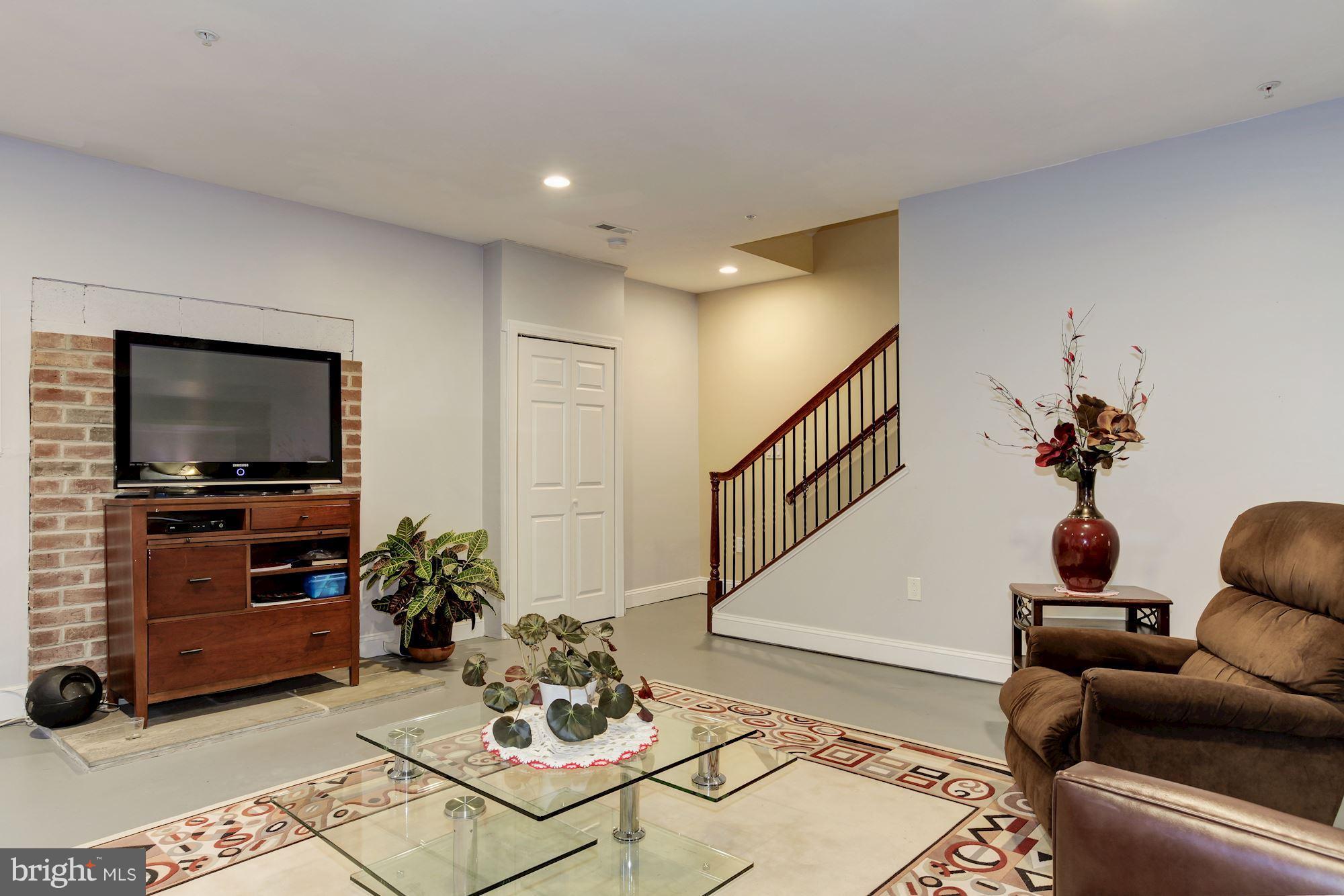 3406 Glorus Place Silver Spring, MD 20902 - Photo 46 of 53 a living room with furniture and a flat screen tv