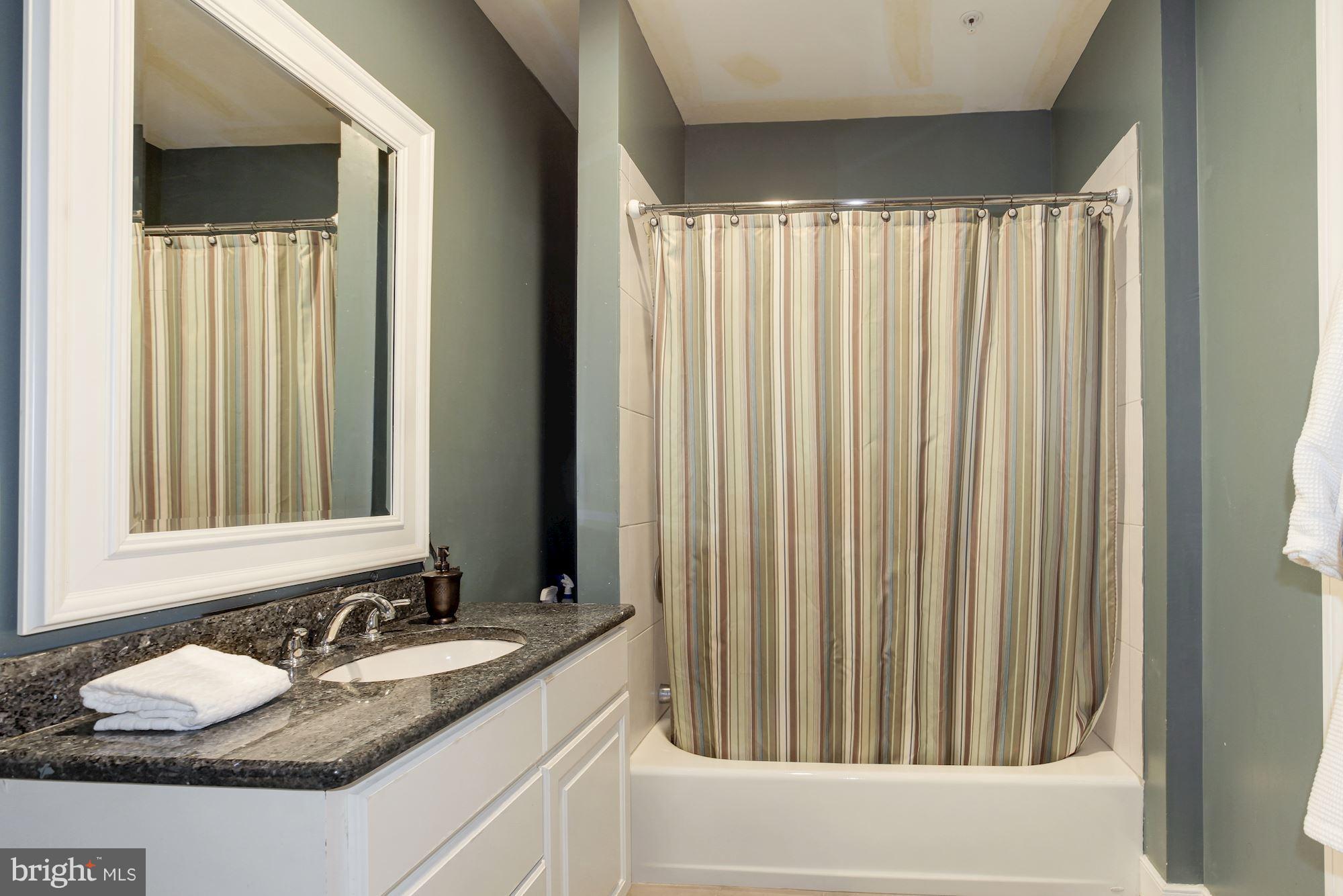 3406 Glorus Place Silver Spring, MD 20902 - Photo 48 of 53 a bathroom with a granite countertop sink and a mirror