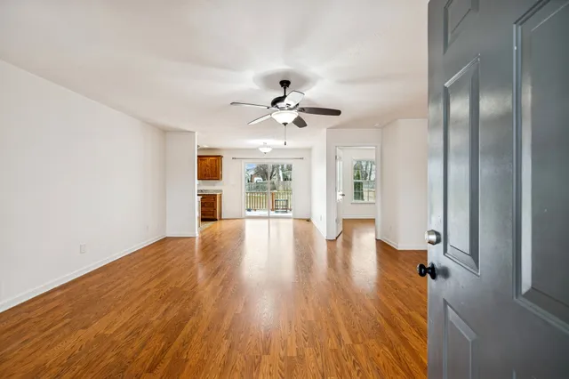 a view of an empty room with wooden floor
