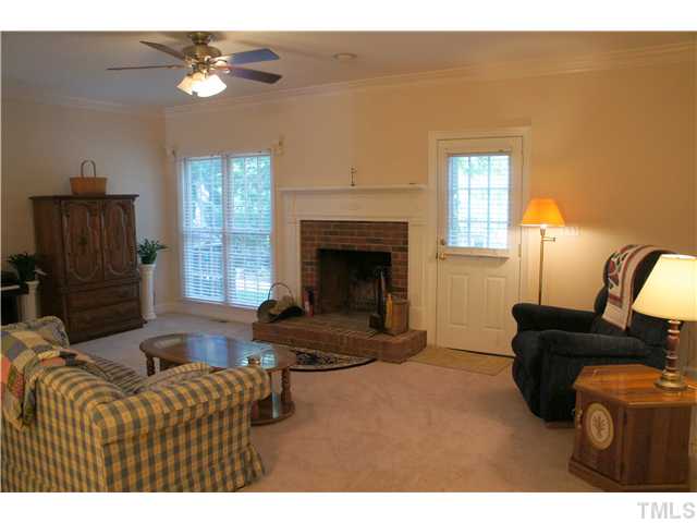 8434 Wycombe Lane Raleigh, NC 27615 - Photo 6 of 19 Great room has brand new carpet, masonry wood burning fireplace, and access to the rear deck.