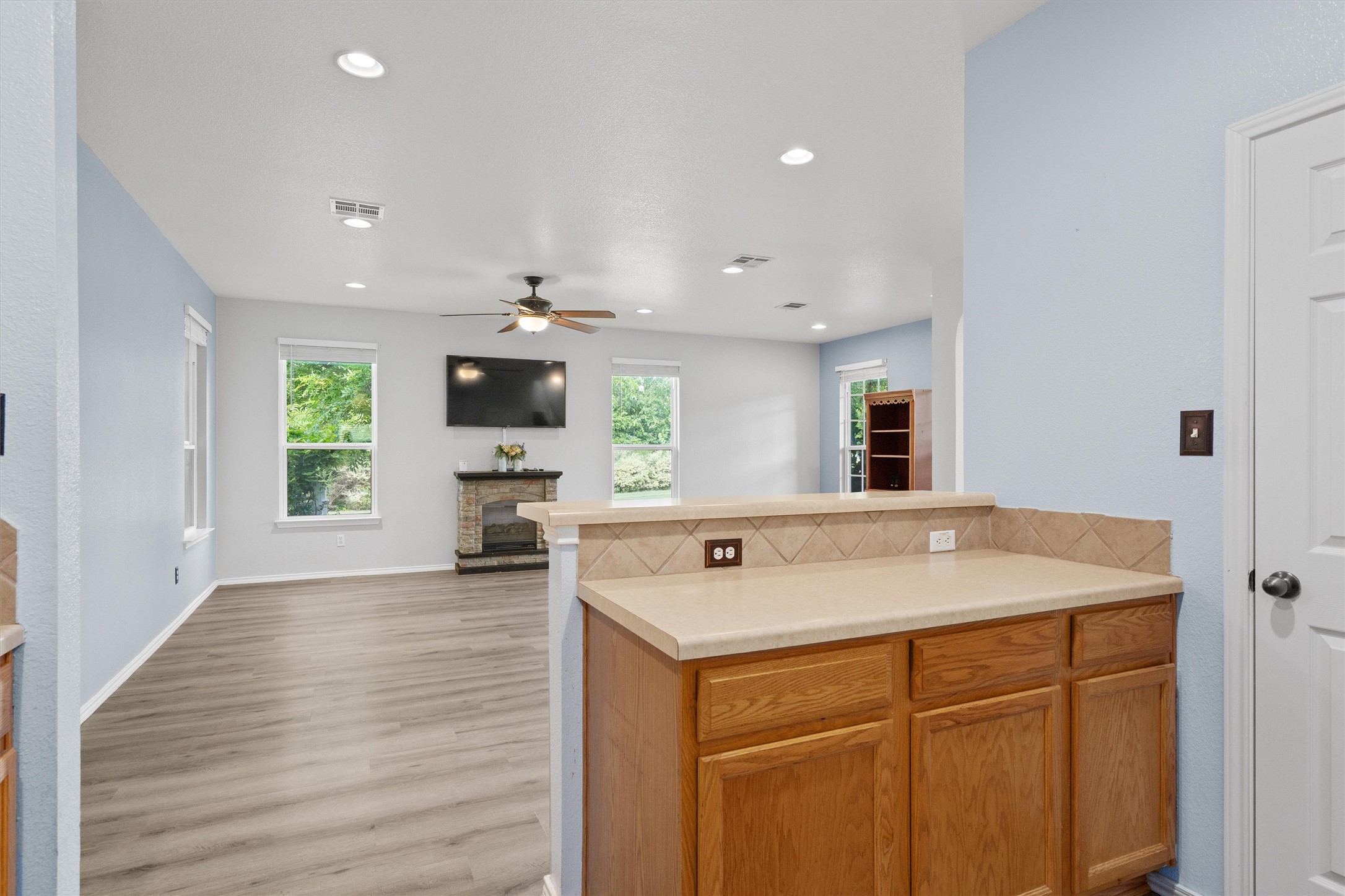 1833 Thompson Trail Round Rock, TX 78664 - Photo 10 of 40 Wood flooring extends through this airy living area, featuring a decorative fireplace.