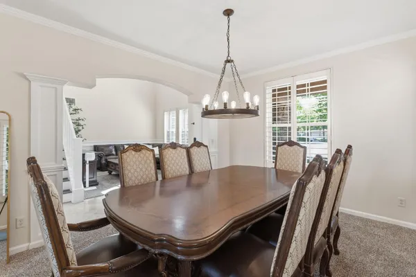 a kitchen with stainless steel appliances granite countertop a sink a stove and a wooden floors