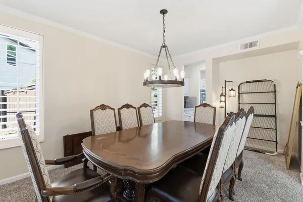 a view of a dining room with furniture and window