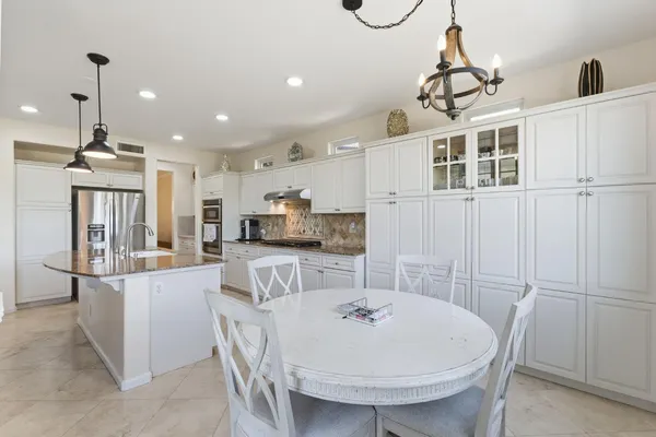 a bedroom with a bed and a chandelier fan