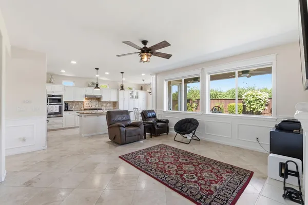 a view of a livingroom with a chandelier fan