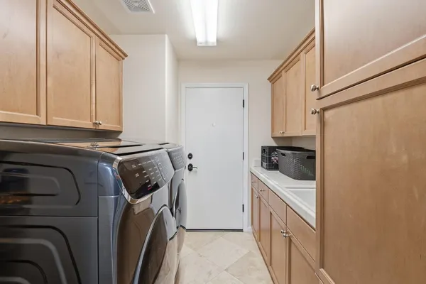 a bathroom with a double vanity sink and a mirror