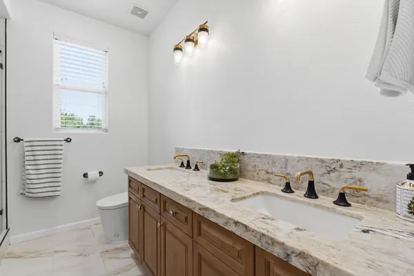 a bathroom with a double vanity sink and a mirror