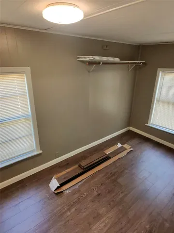 a view of a room with wooden floor