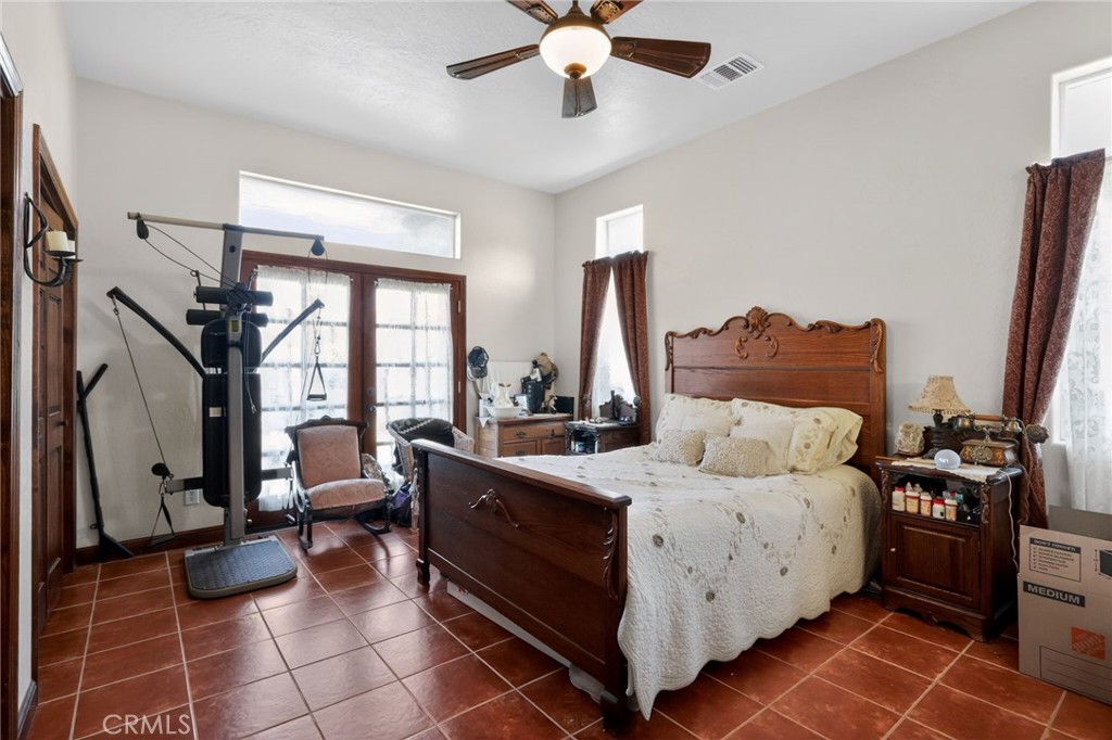 11701 Back Canyon Road Caliente, CA 93518 - Photo 15 of 26 a bedroom with a bed and a chandelier