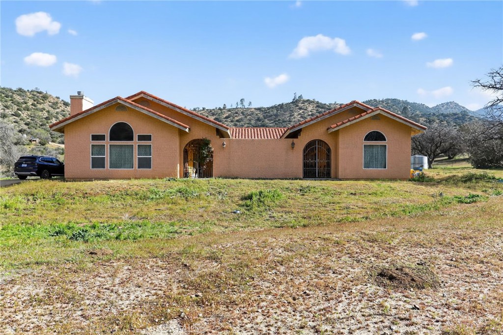 11701 Back Canyon Road Caliente, CA 93518 - Photo 22 of 26 a front view of a house with a yard and garage