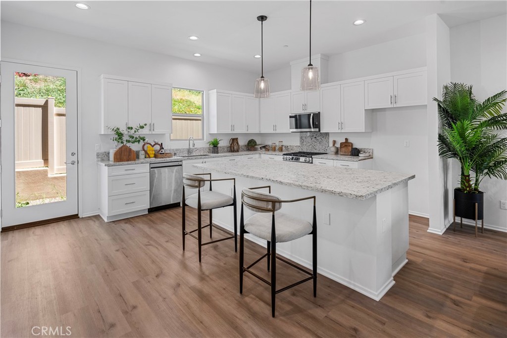 816 Francesca Drive Walnut, CA 91789 - Photo 4 of 14 a kitchen with stainless steel appliances granite countertop wooden floor window and cabinets