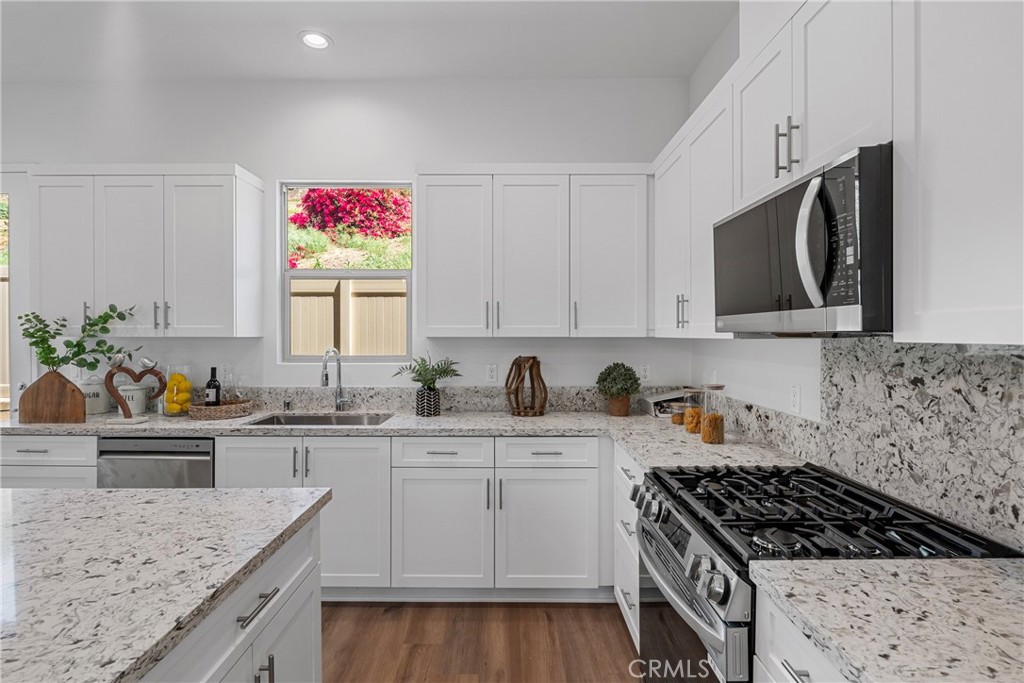 816 Francesca Drive Walnut, CA 91789 - Photo 6 of 14 a kitchen with granite countertop a sink stove top oven and cabinets
