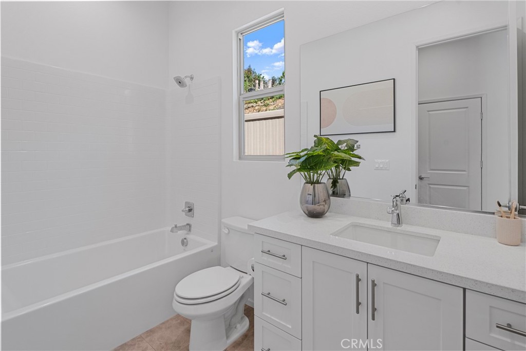 816 Francesca Drive Walnut, CA 91789 - Photo 7 of 14 a bathroom with a granite countertop toilet a sink and a mirror