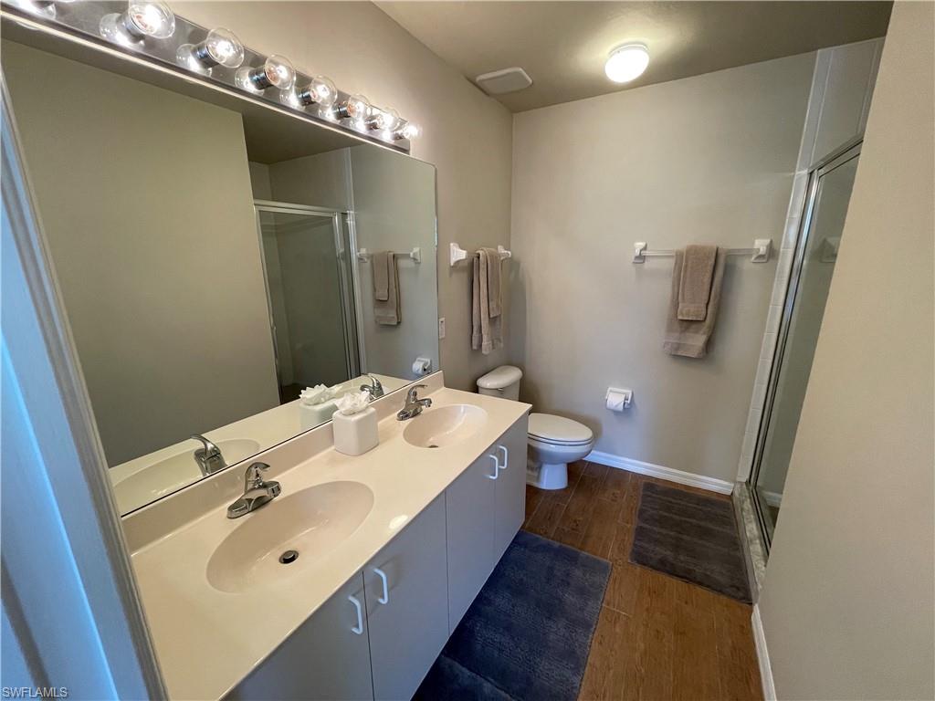 519 Roma Court, Unit 2103 Naples, FL 34110 - Photo 14 of 27 a bathroom with a sink and mirror with toilet
