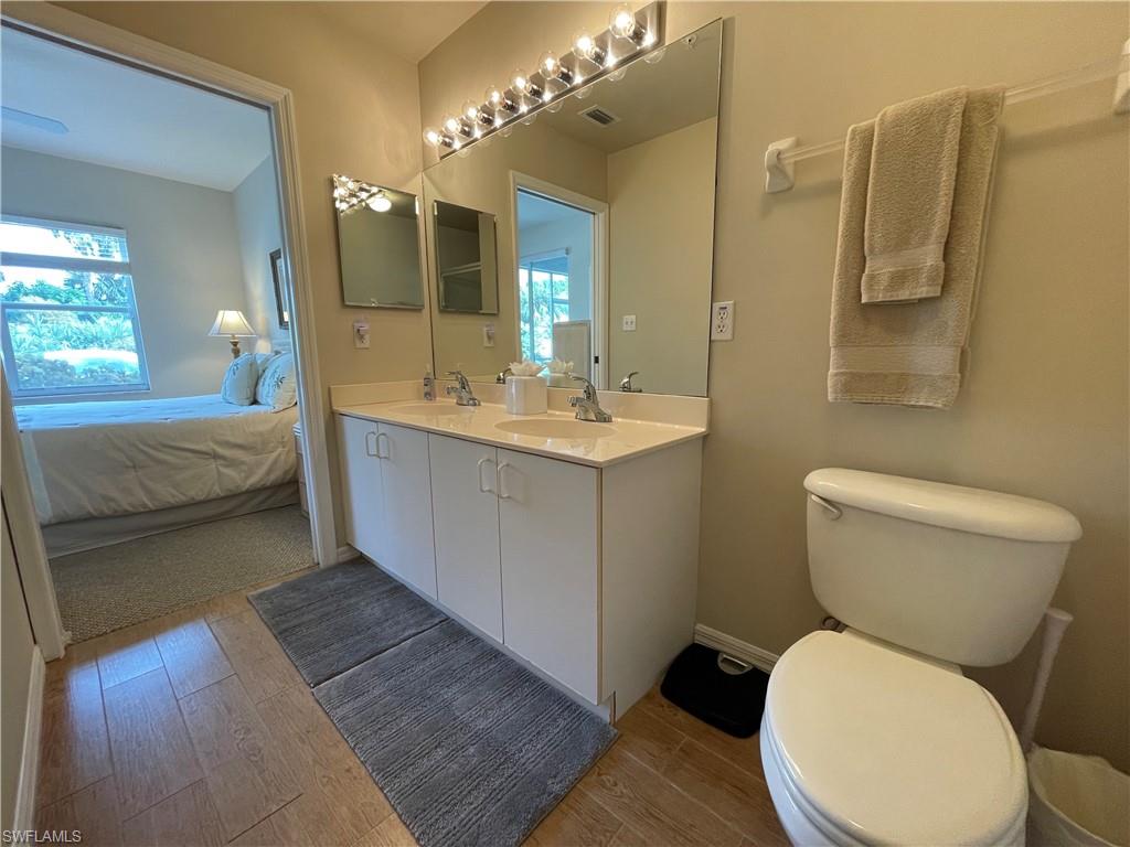 519 Roma Court, Unit 2103 Naples, FL 34110 - Photo 15 of 27 a bathroom with a toilet sink and mirror