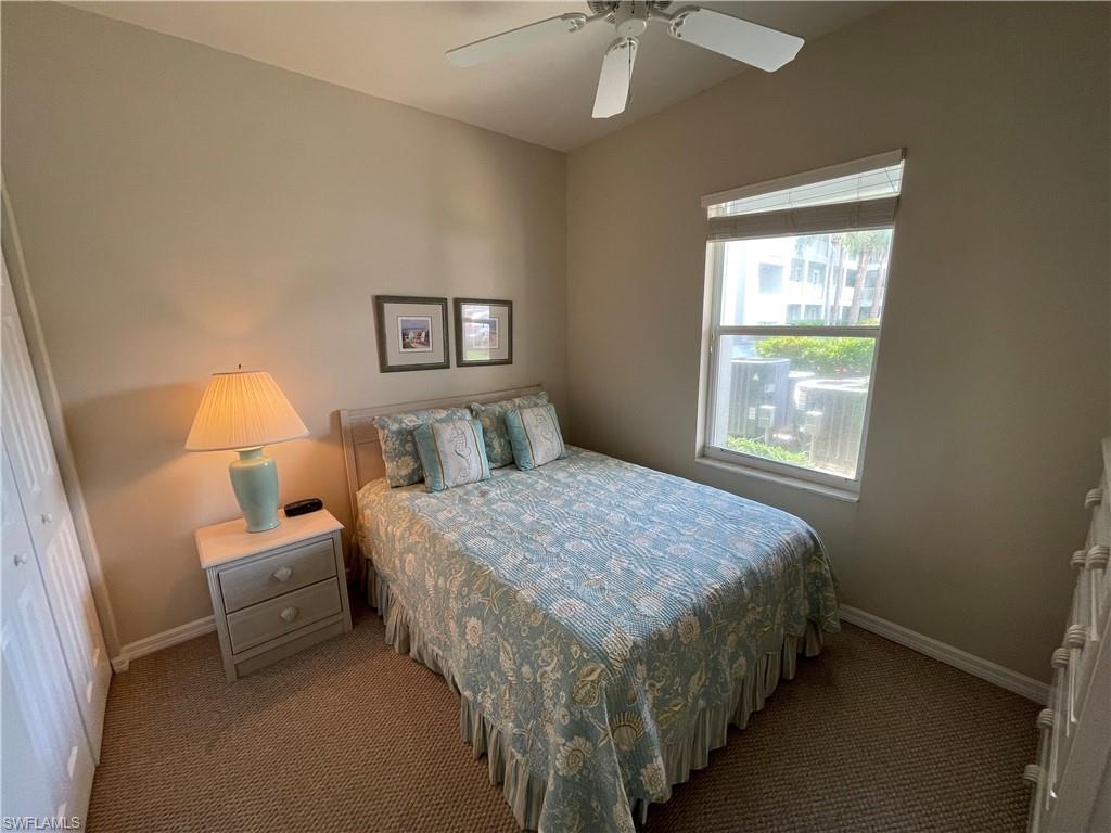 519 Roma Court, Unit 2103 Naples, FL 34110 - Photo 16 of 27 a bedroom with a bed and a window