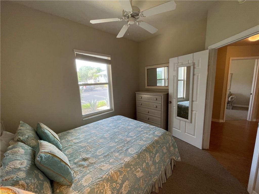 519 Roma Court, Unit 2103 Naples, FL 34110 - Photo 17 of 27 a bedroom with a bed dresser and a window