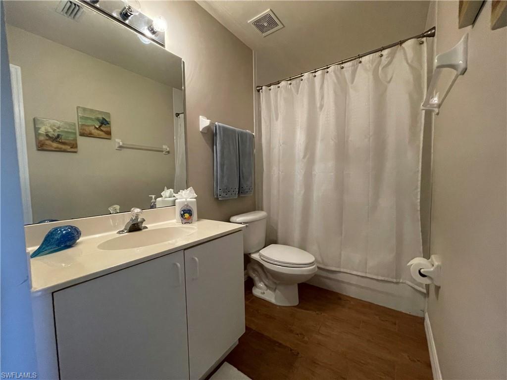 519 Roma Court, Unit 2103 Naples, FL 34110 - Photo 18 of 27 a bathroom with a sink a toilet and shower