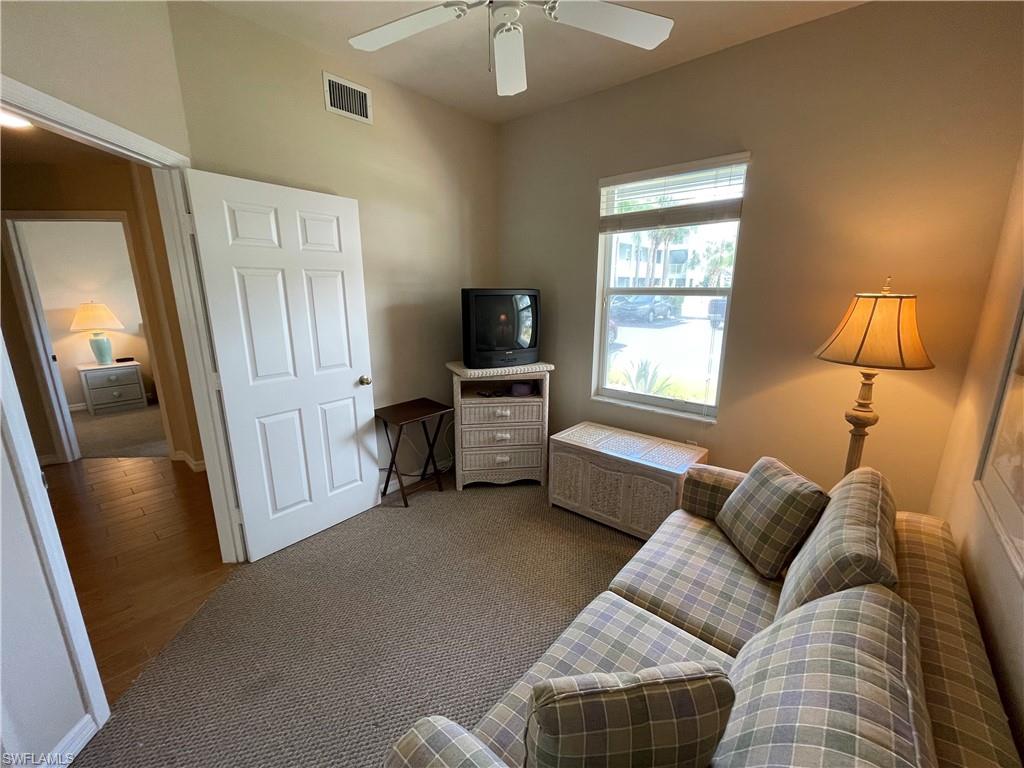 519 Roma Court, Unit 2103 Naples, FL 34110 - Photo 20 of 27 a living room with furniture and a flat screen tv