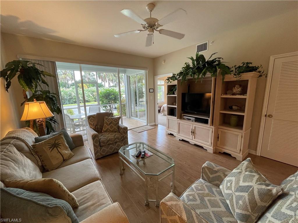 519 Roma Court, Unit 2103 Naples, FL 34110 - Photo 2 of 27 a living room with furniture and a flat screen tv