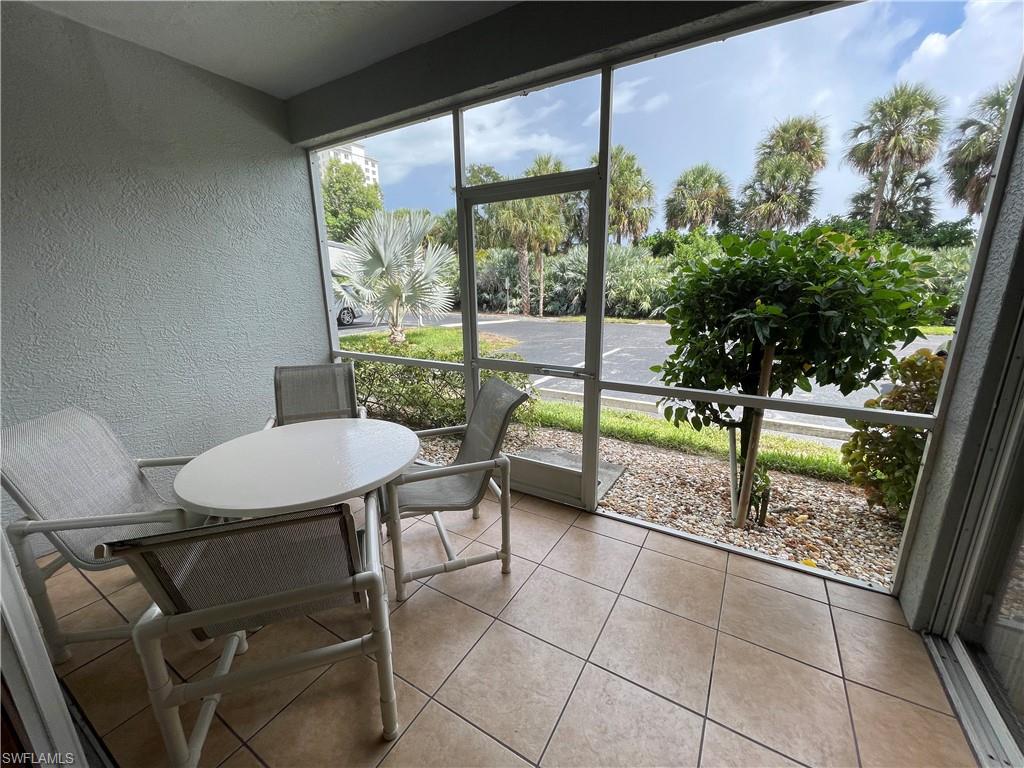 519 Roma Court, Unit 2103 Naples, FL 34110 - Photo 21 of 27 a view of a porch with furniture and a yard