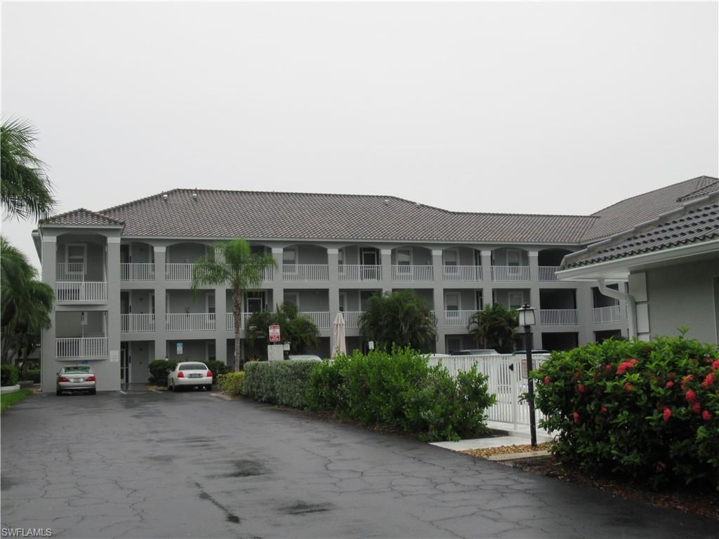519 Roma Court, Unit 2103 Naples, FL 34110 - Photo 26 of 27 a front view of a house with garden