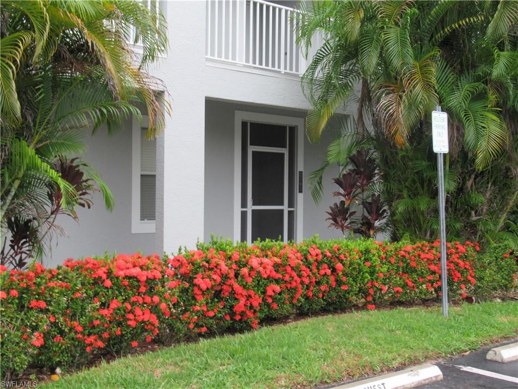 519 Roma Court, Unit 2103 Naples, FL 34110 - Photo 27 of 27 a bunch of flowers in front of a house