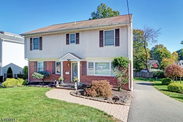 a front view of a house with porch and garden