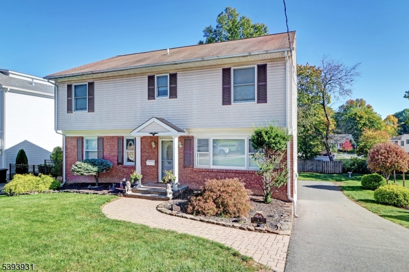 a front view of a house with porch and garden