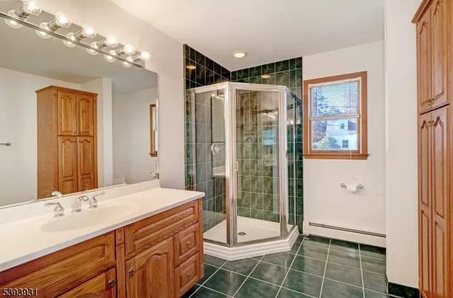 a bathroom with a double vanity sink toilet and shower