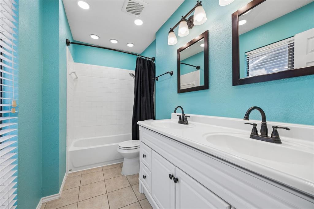 709 Bowie Street Forney, TX 75126 - Photo 18 of 27 a bathroom with a sink a toilet and shower