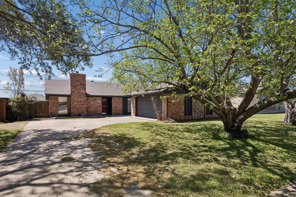 709 Bowie Street Forney, TX 75126 - Photo 7 of 27 a house that has a tree in front of it