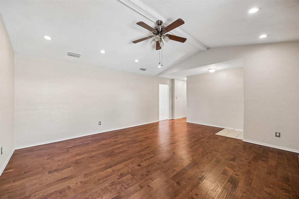 709 Bowie Street Forney, TX 75126 - Photo 9 of 27 an empty room with ceiling fan and windows