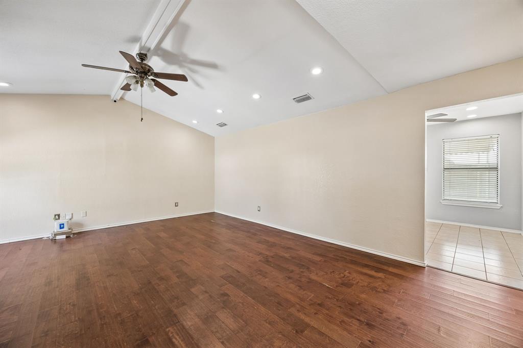 709 Bowie Street Forney, TX 75126 - Photo 10 of 27 wooden floor in an empty room with a window