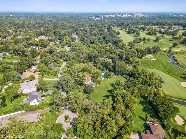 a view of a city with lush green forest