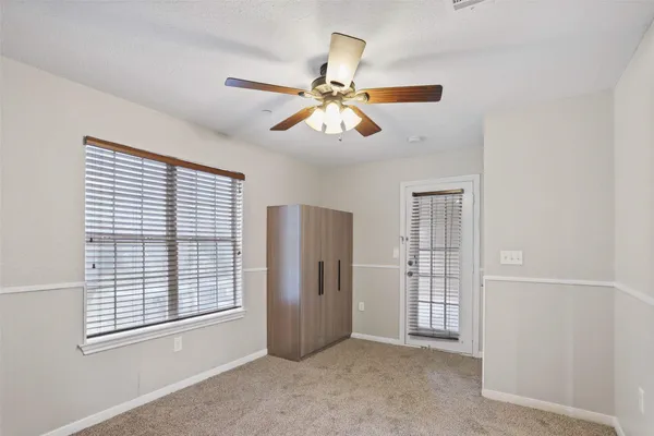 a view of a livingroom with a ceiling fan and window
