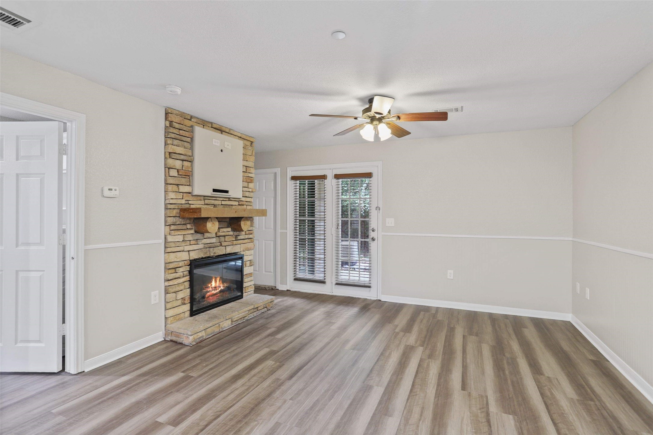 11700 League Line Road, Unit 122 Conroe, TX 77304 - Photo 2 of 25 wooden floor in an empty room with a window