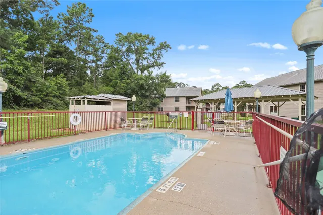 a view of a backyard with swimming pool