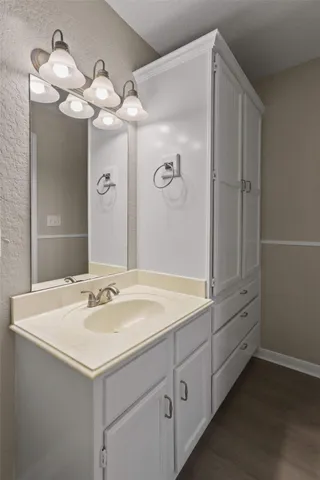 a bathroom with a sink a mirror and a shower