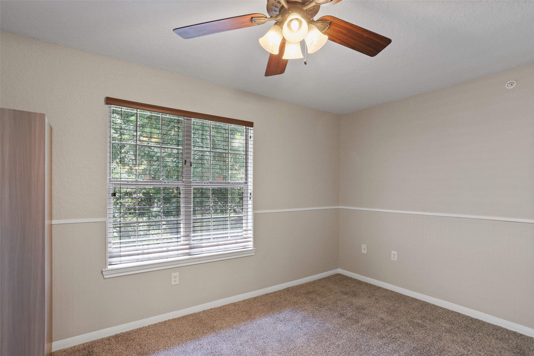 11700 League Line Road, Unit 122 Conroe, TX 77304 - Photo 7 of 25 a view of an empty room with a window and a chandelier fan