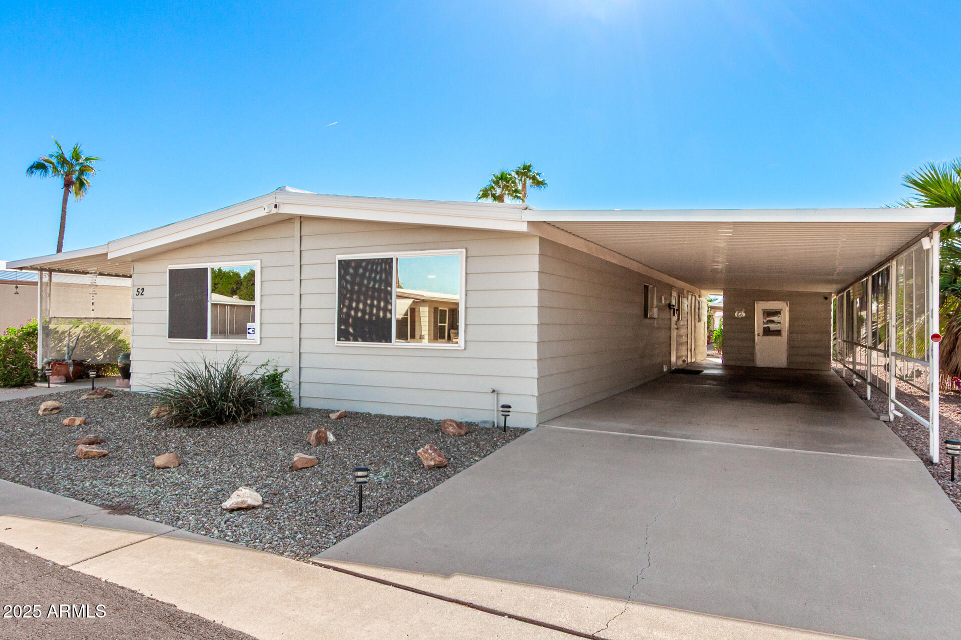 661 South Hawes Road, Unit 52 Mesa, AZ 85208 - Photo 21 of 36 a front view of a house with garden