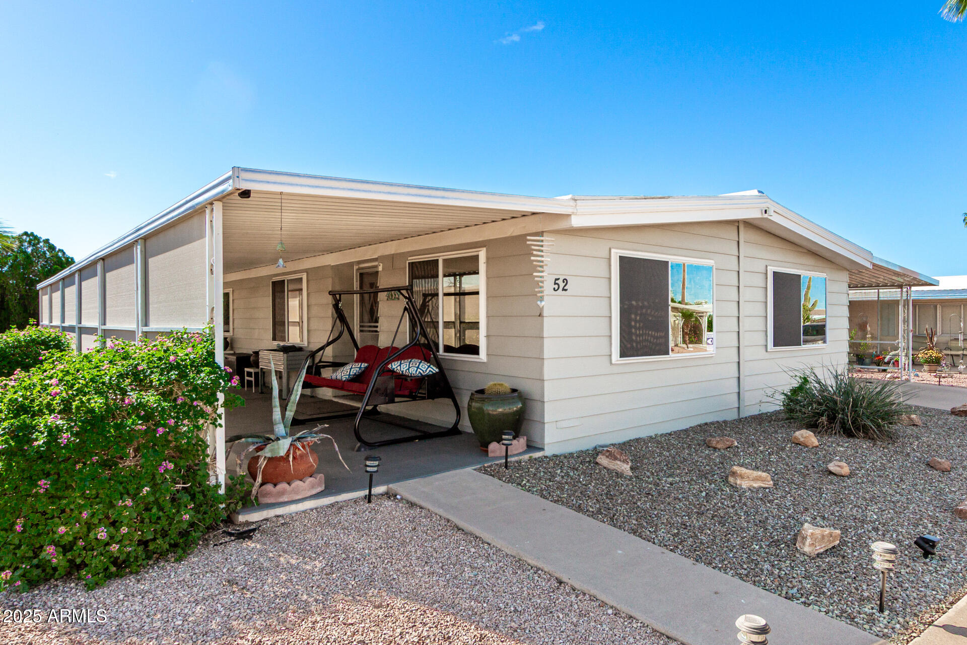 661 South Hawes Road, Unit 52 Mesa, AZ 85208 - Photo 23 of 36 a view of a house with a patio