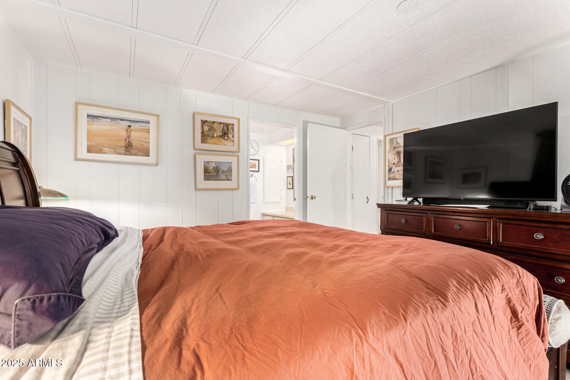 661 South Hawes Road, Unit 52 Mesa, AZ 85208 - Photo 29 of 36 a bedroom with a bed and a flat screen tv