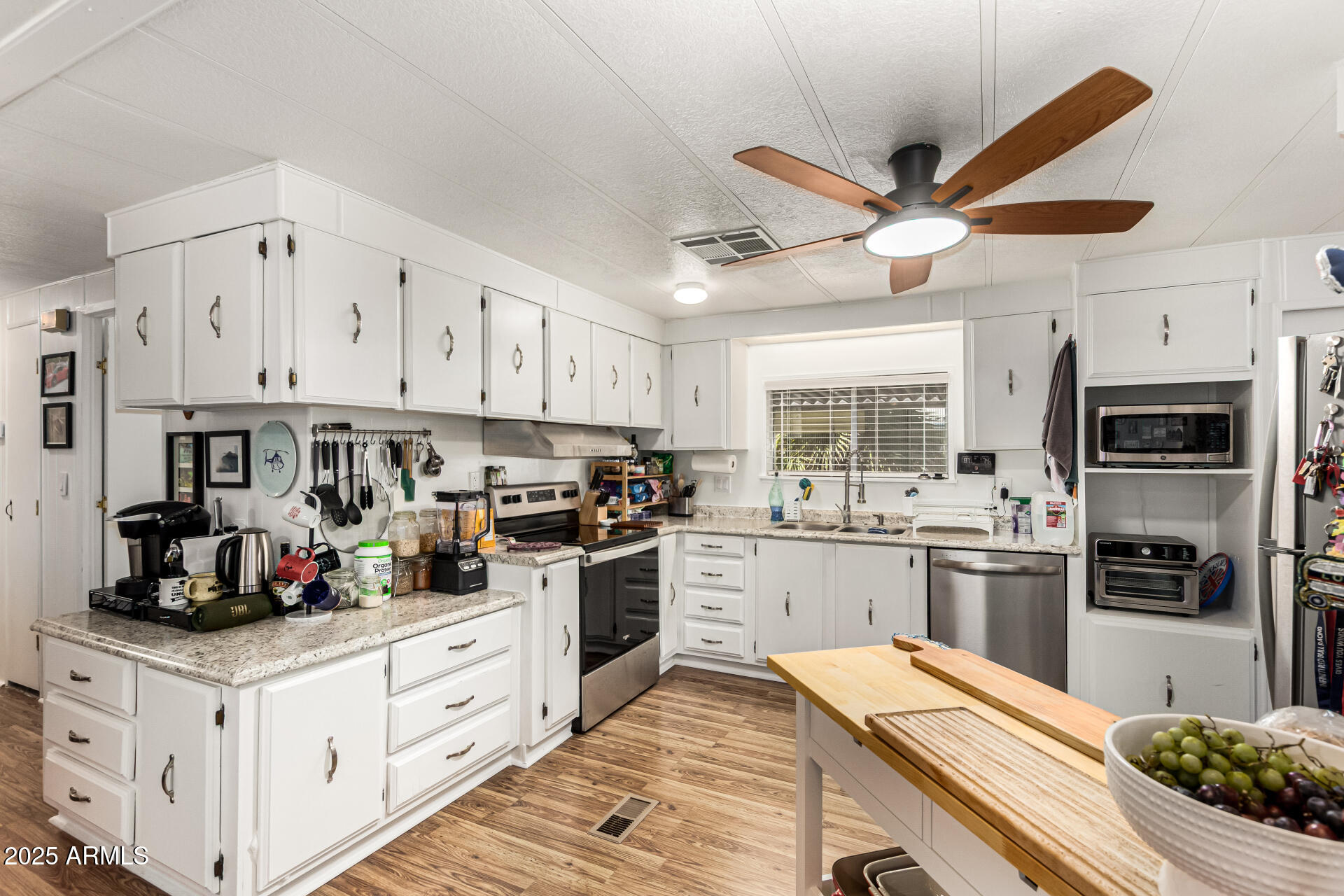 661 South Hawes Road, Unit 52 Mesa, AZ 85208 - Photo 3 of 36 a kitchen with refrigerator a stove and cabinets