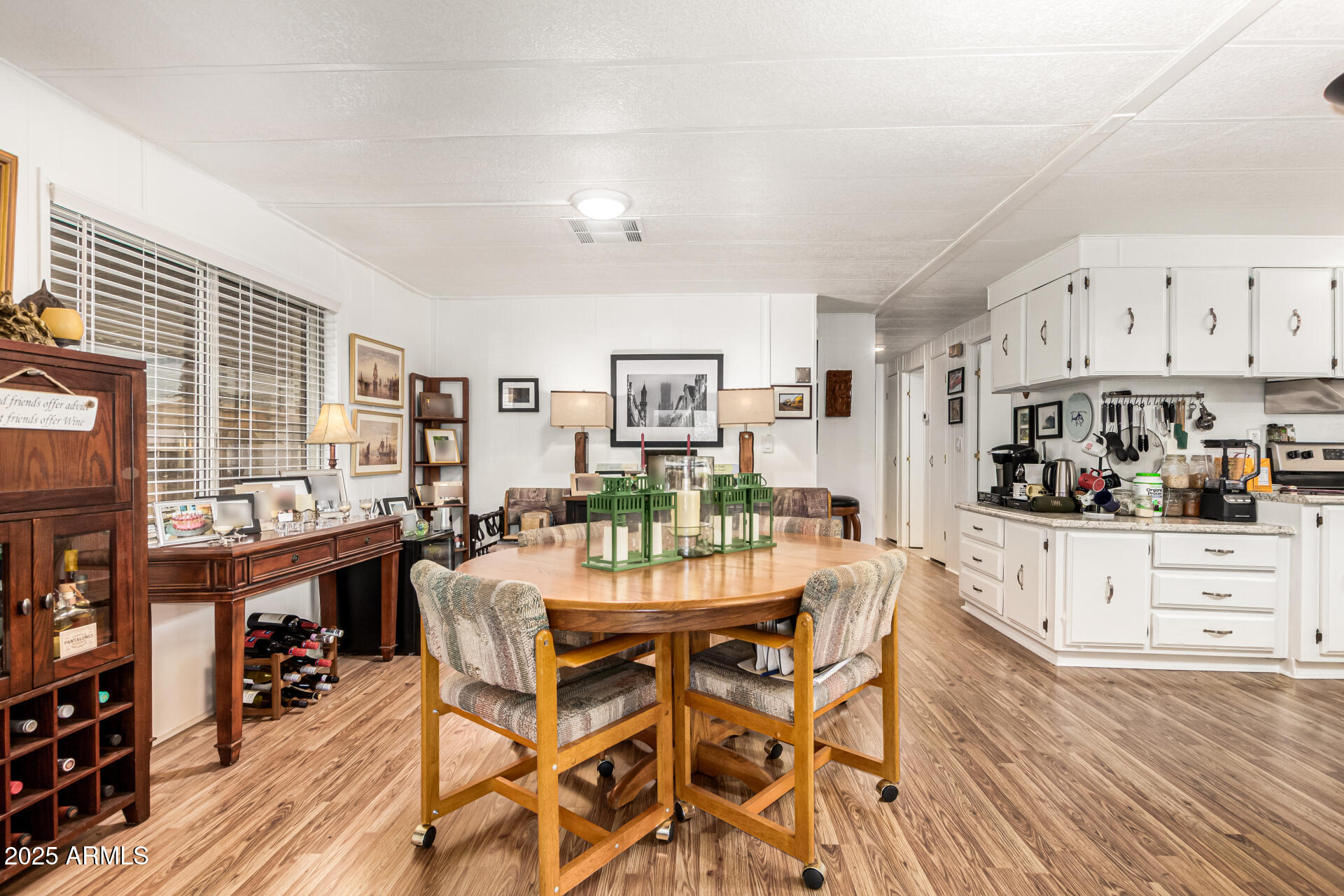 661 South Hawes Road, Unit 52 Mesa, AZ 85208 - Photo 4 of 36 a view of a dining room with furniture and wooden floor