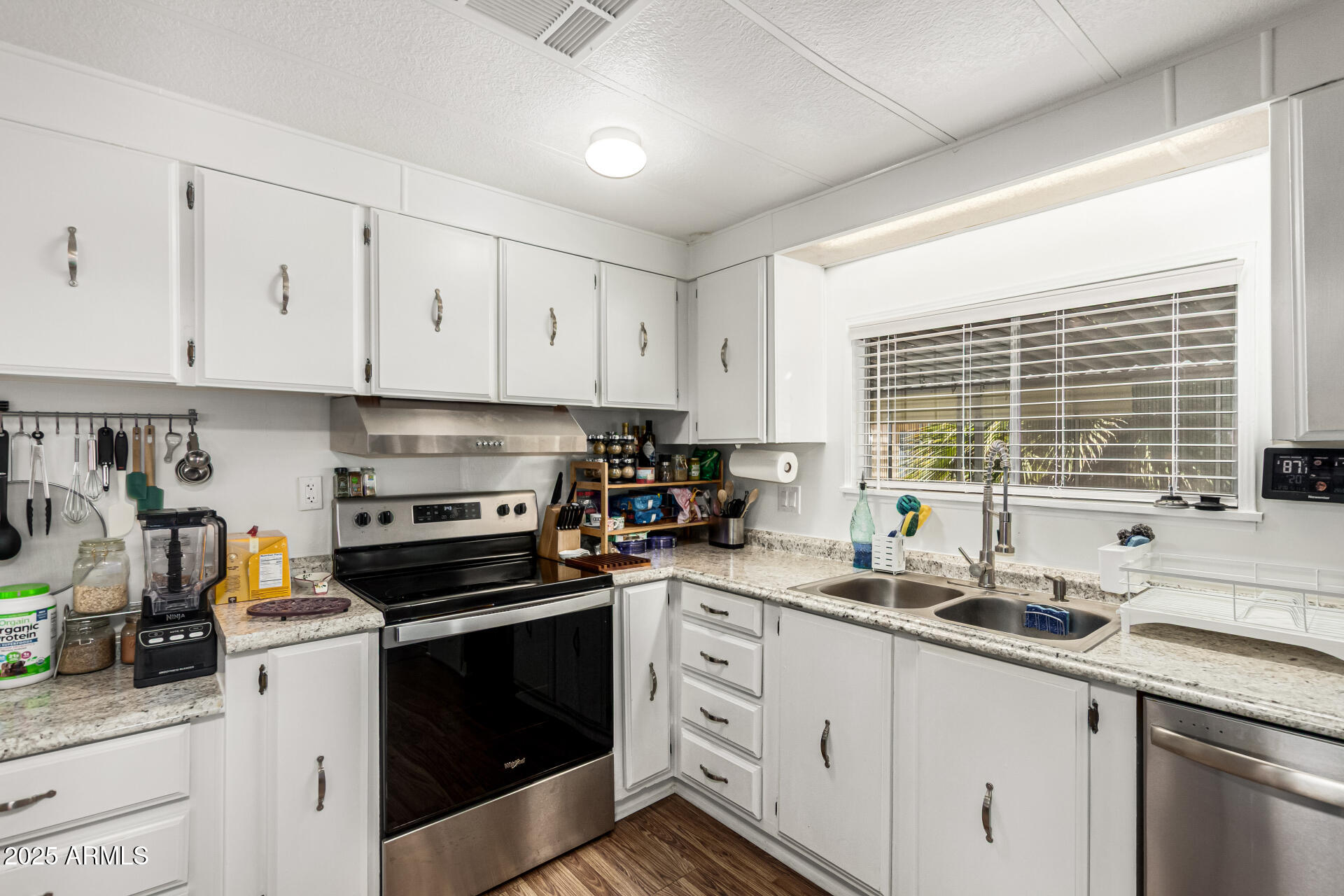 661 South Hawes Road, Unit 52 Mesa, AZ 85208 - Photo 5 of 36 a kitchen with sink a stove and cabinets