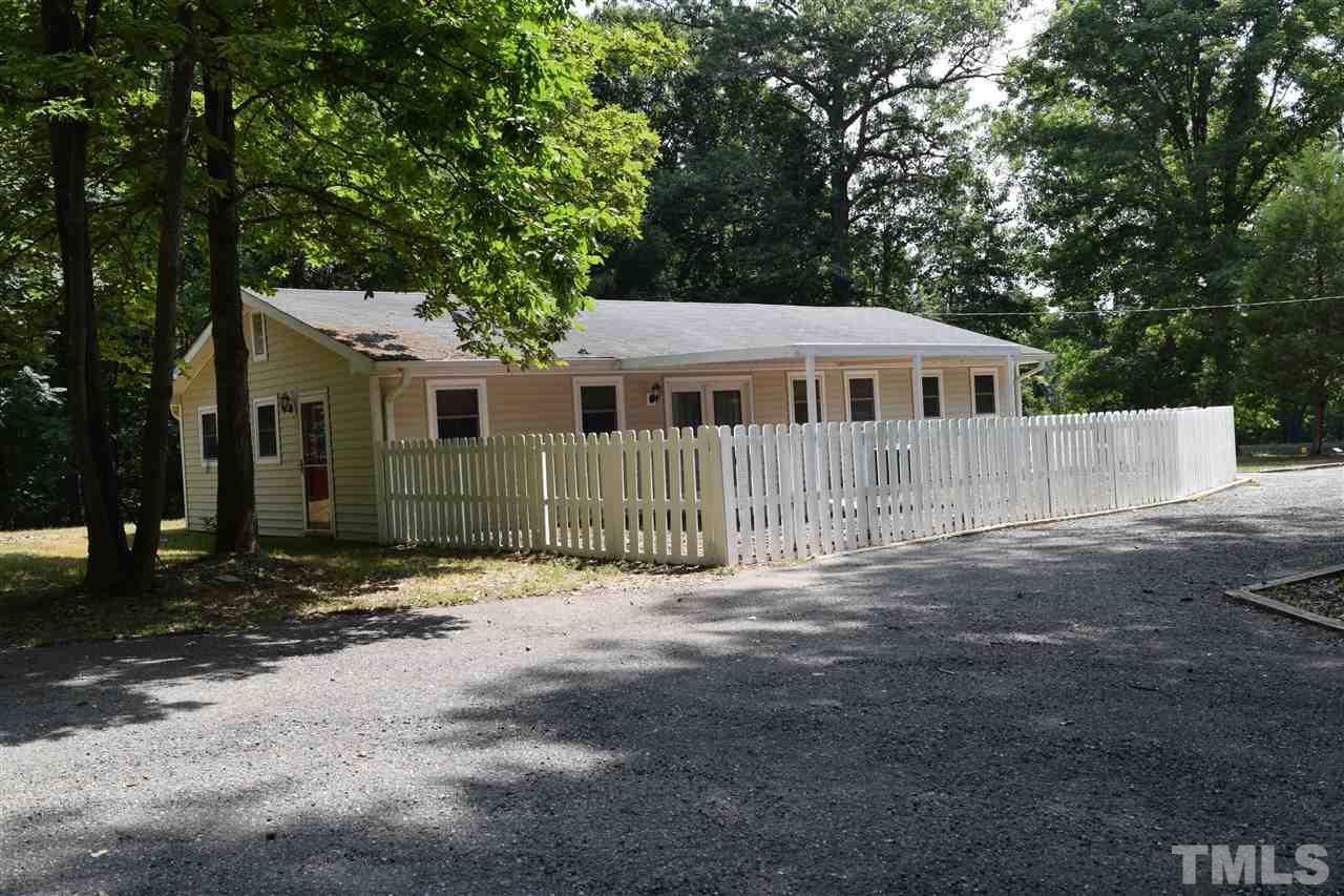 89 Mountain Ridge Road Rougemont, NC 27572 - Photo 2 of 16 a front view of a house with a garden
