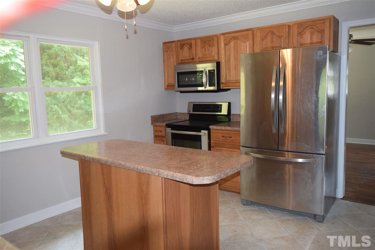 89 Mountain Ridge Road Rougemont, NC 27572 - Photo 11 of 16 a kitchen with stainless steel appliances granite countertop a refrigerator a stove a sink dishwasher and microwave