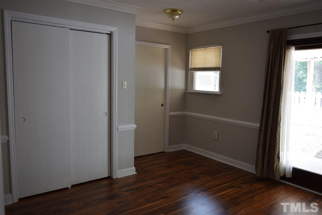 89 Mountain Ridge Road Rougemont, NC 27572 - Photo 13 of 16 an empty room with wooden floor and windows